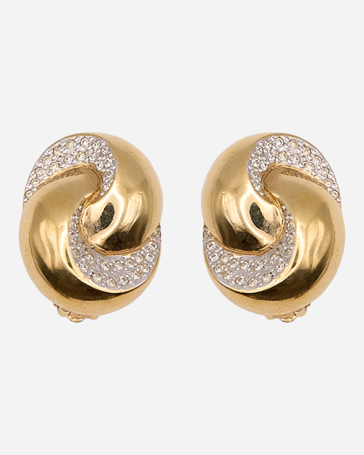 Orecchini vintage ovali con motivo a nodo dorato e fasce curve di cristalli a pavé su fondo argentato.