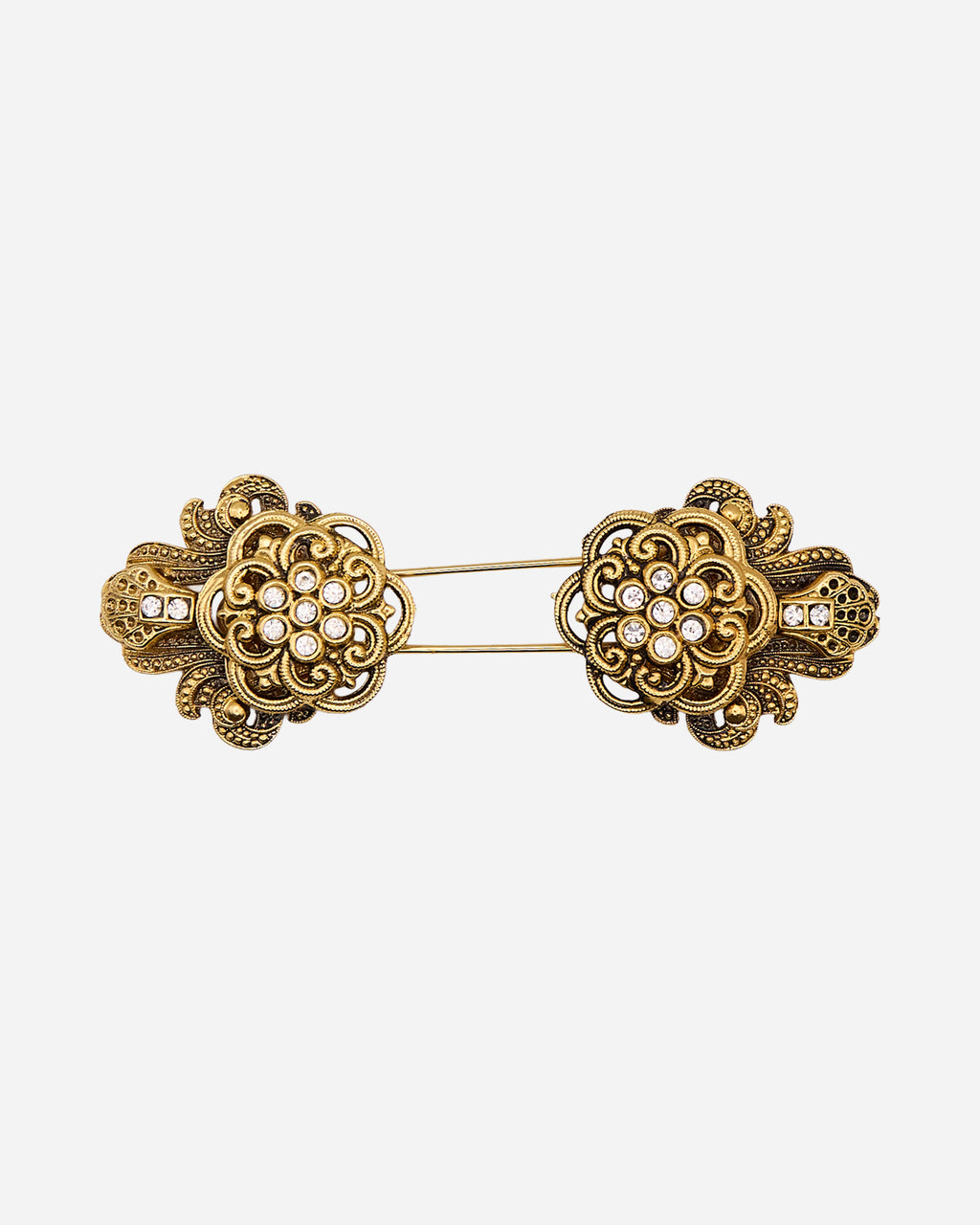 Spilla vintage a spillone in metallo dorato con due rosette speculari traforate e cristalli trasparenti.