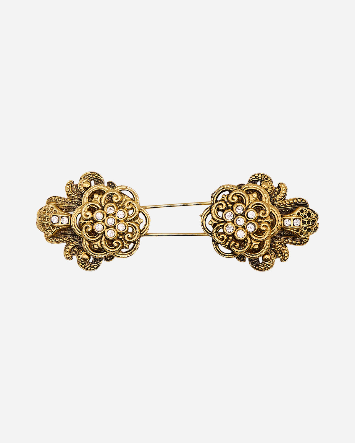Spilla vintage a spillone in metallo dorato con due rosette speculari traforate e cristalli trasparenti.